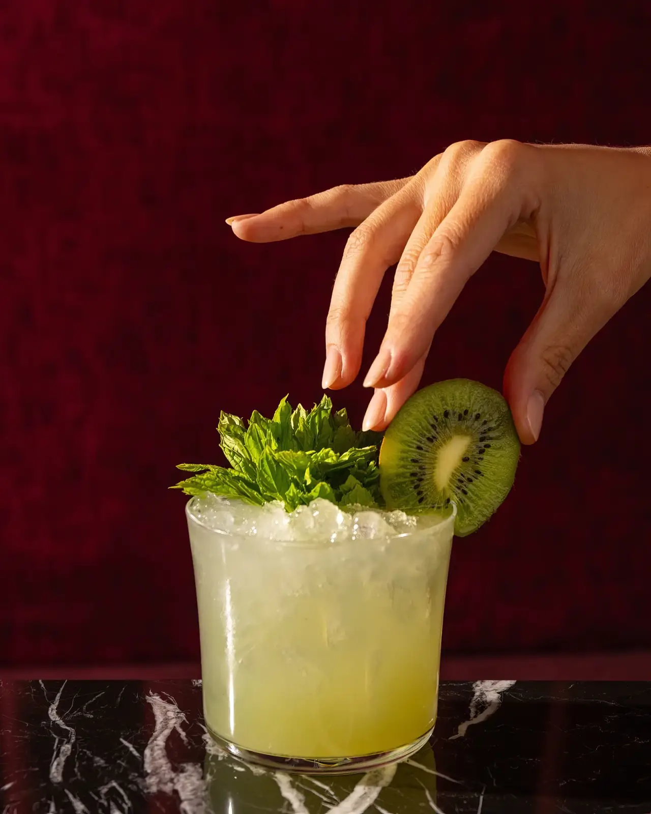 A cocktail garnished at the table